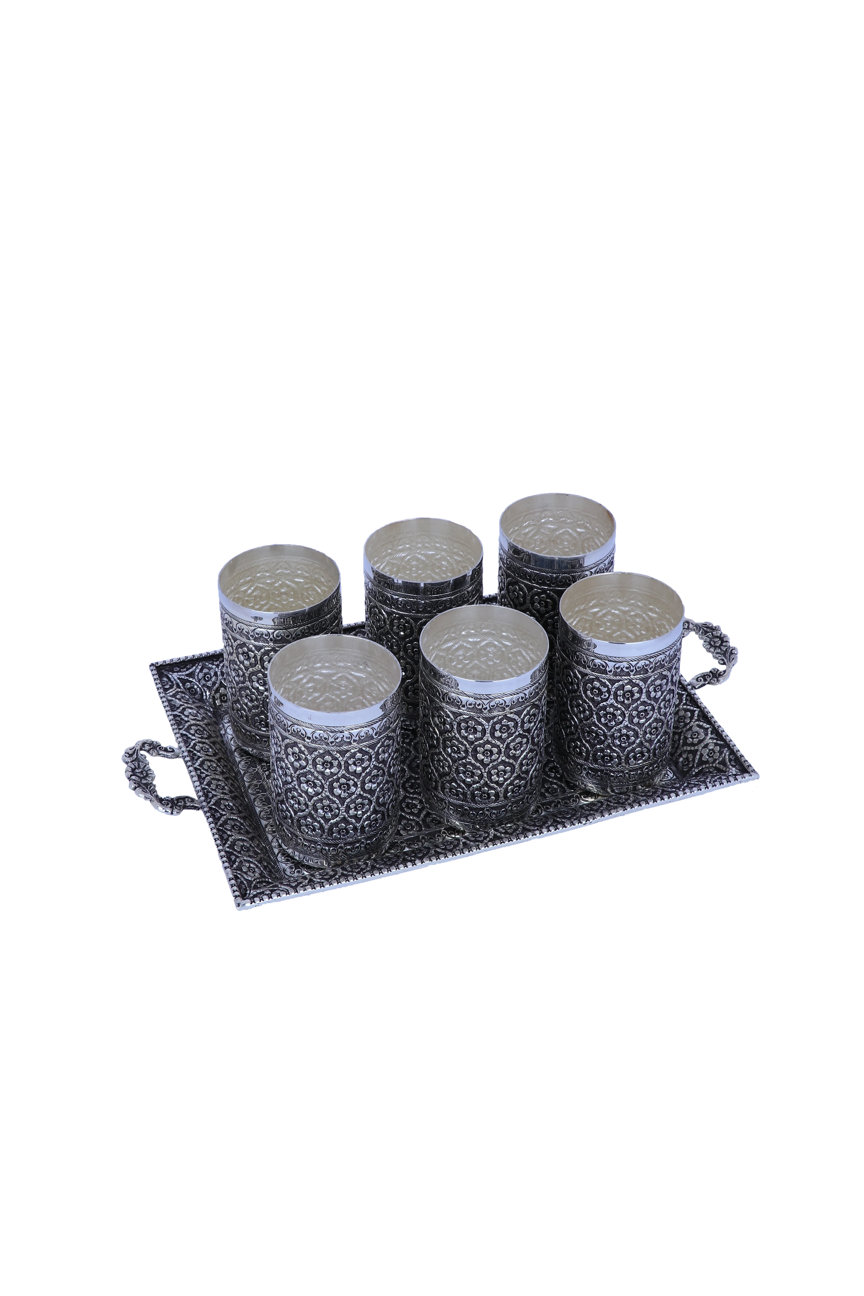 Silver fluted tumbler set with patterned cups arranged on tray