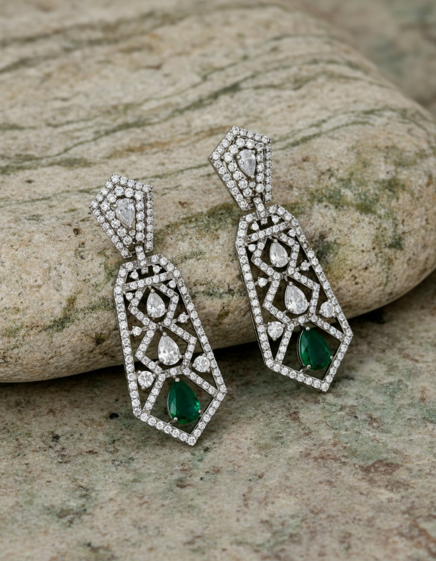 Shop crystal-studded silver earrings for women with an elegant long design and green teardrop accents.