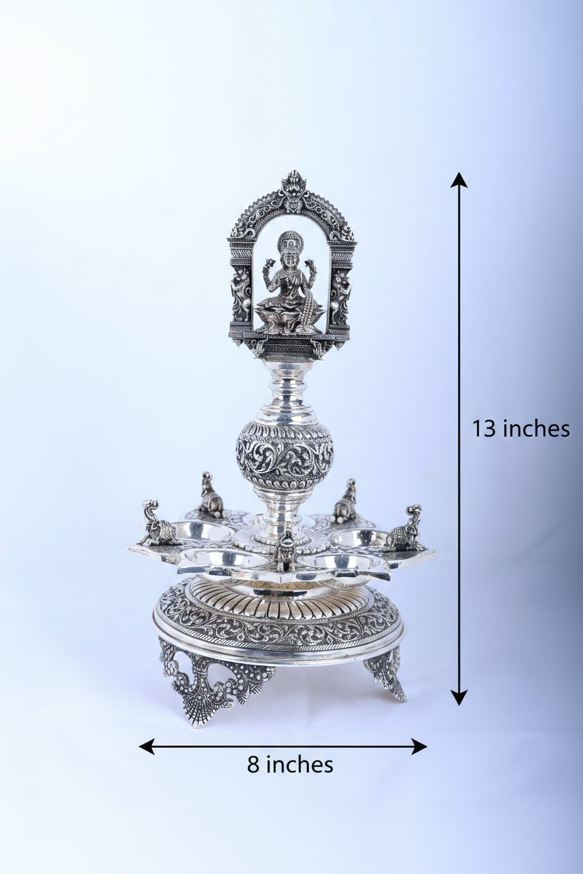 Ornate silver-tone temple diya stand, 13 in tall, 8 in wide, Lakshmi relief