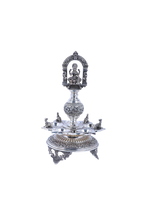 Ornate silver-tone temple diya set with Lakshmi relief, multi-tier base and central stem