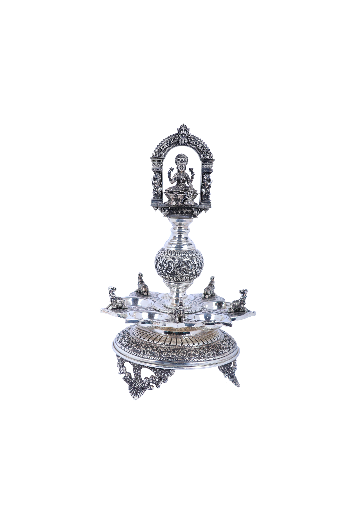 Ornate silver-tone temple diya set with Lakshmi relief, multi-tier base and central stem