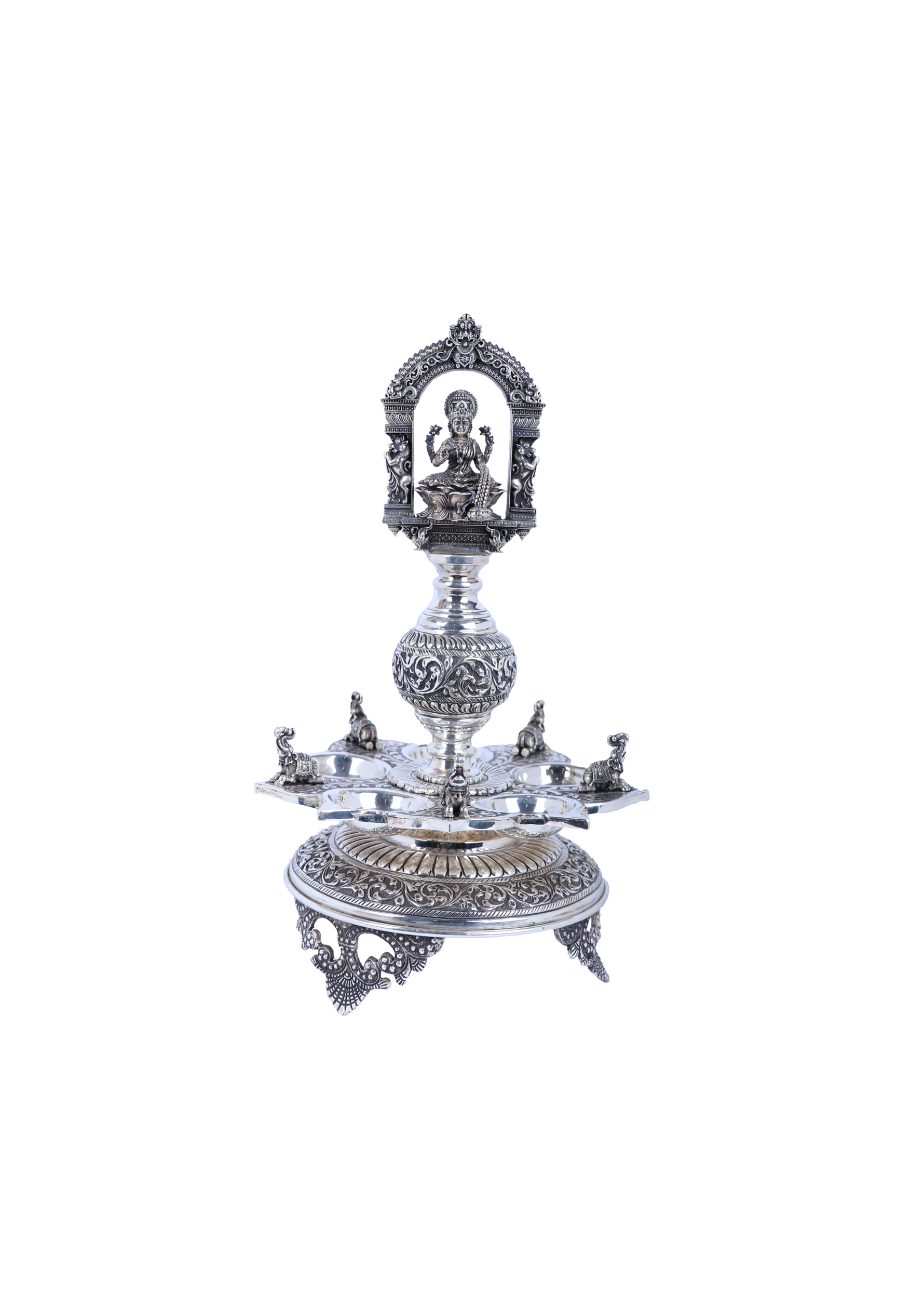Ornate silver-tone temple diya set with Lakshmi relief, multi-tier base and central stem