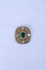Silver brooch for men with green stone and crystal detailing on a formal sherwani.