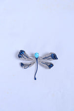 Blue and silver bow rhinestone brooch with light-blue center bead and blue ties