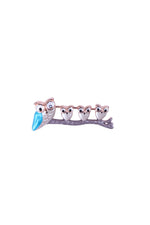 Silver brooch with five owl faces and blue beaks