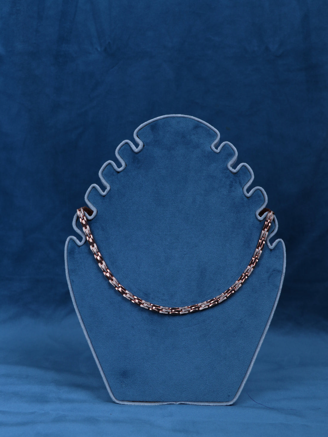 Silver-tone necklace chain with multicolor link accents on a display bust