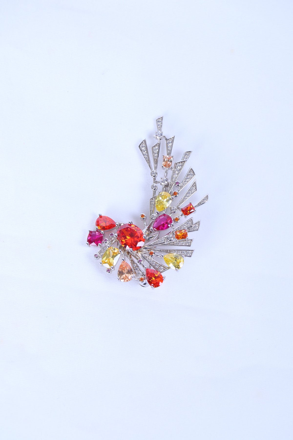 Silver lapel brooch for men with peacock feather design and crystal accents for ethnic wear.