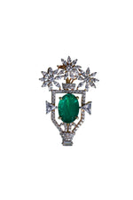 Silver designer brooch with green oval center and starburst crystal surround