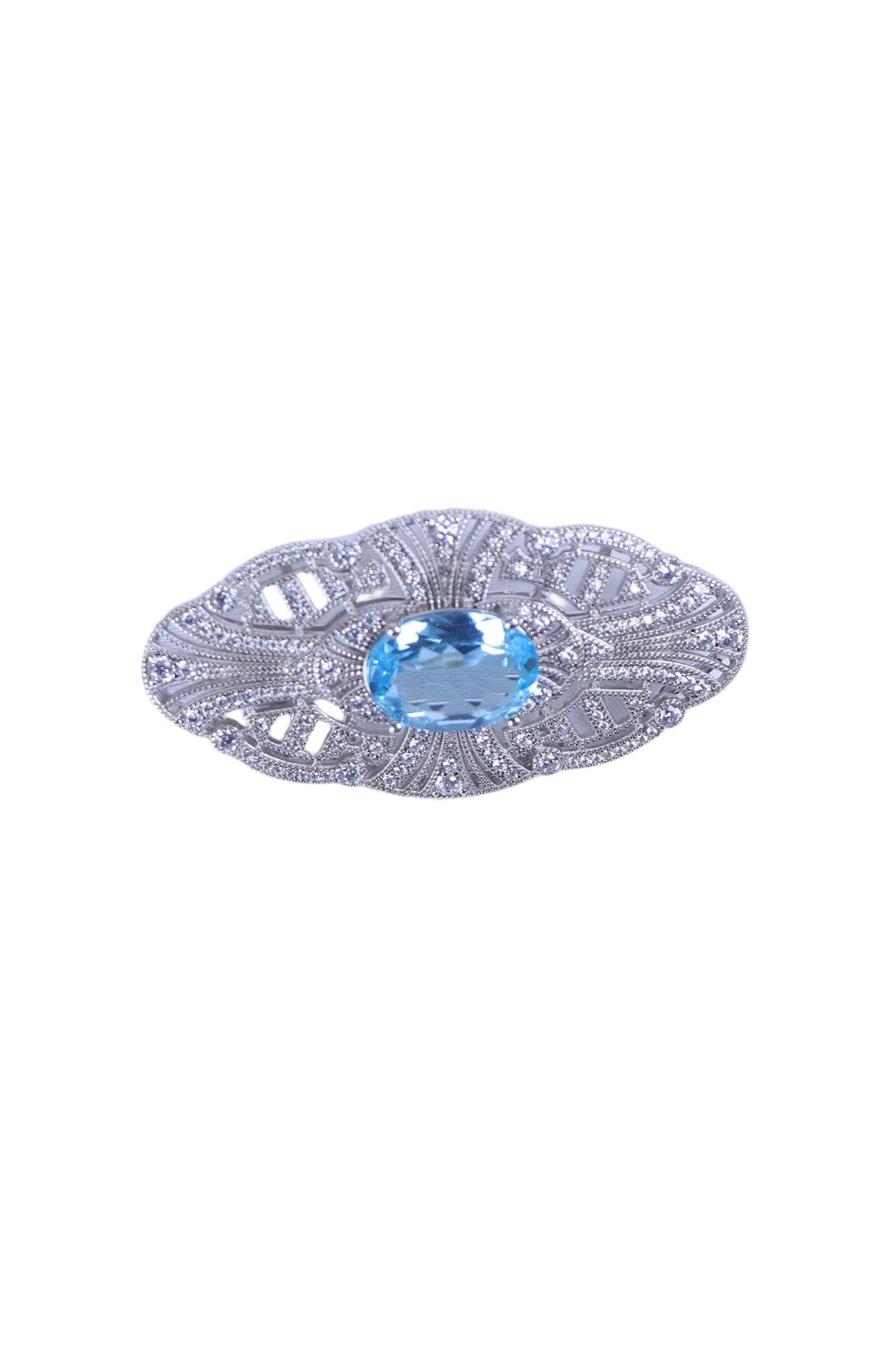 Silver designer brooch with oval blue gemstone and ornate filigree settings