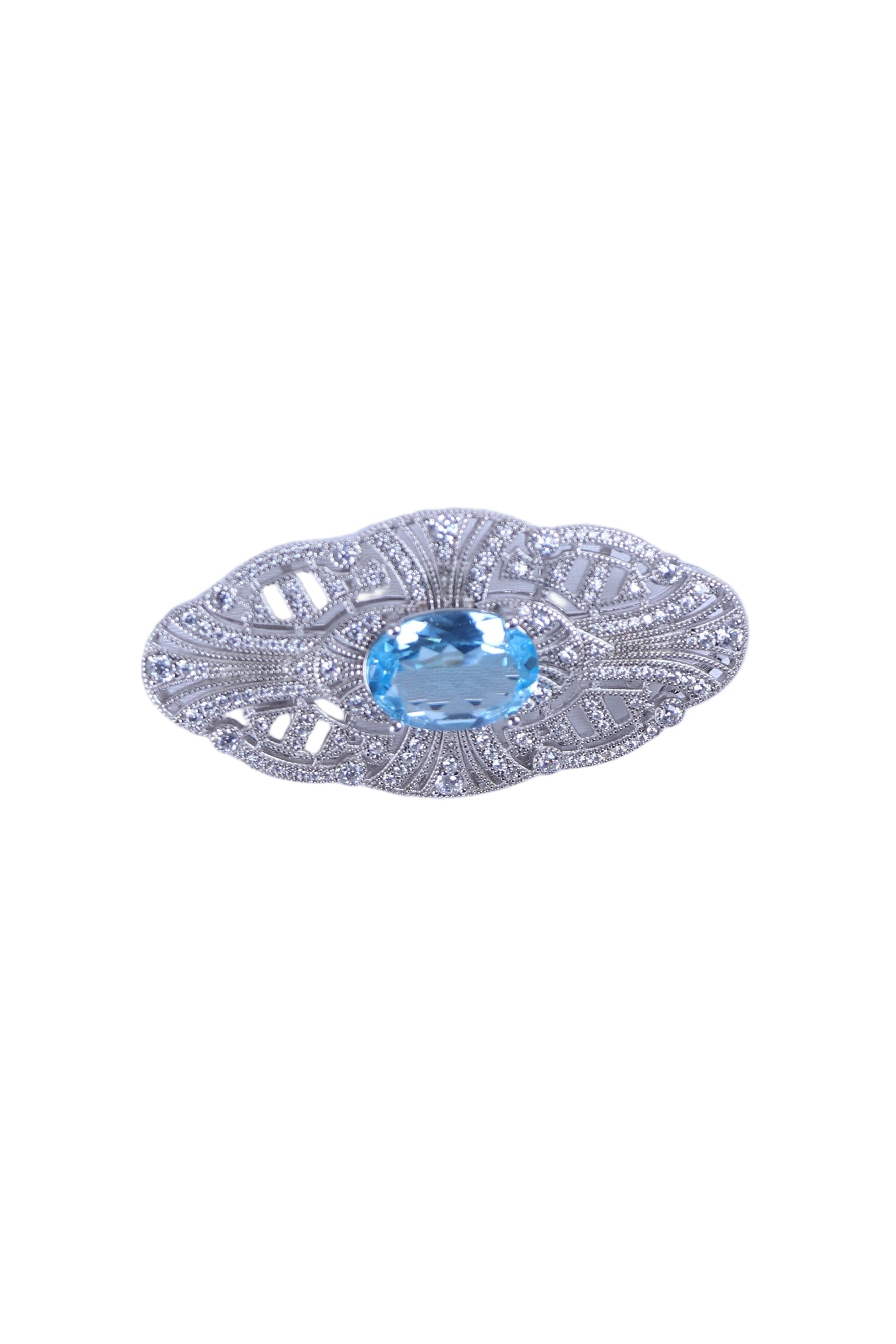 Silver designer brooch with oval blue gemstone and ornate filigree settings