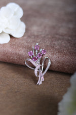 Silver heart ribbon brooch with pink square crystals, close-up