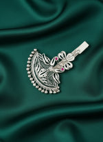 Silver peacock keychain charm close-up with filigree details, pink stones, and clasp
