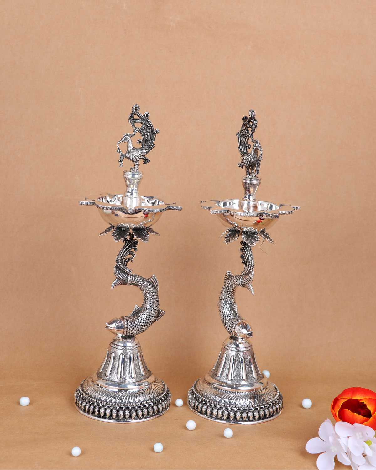 Silver-tone standing samai pair, two bird-topped serpent candle holders on round bases