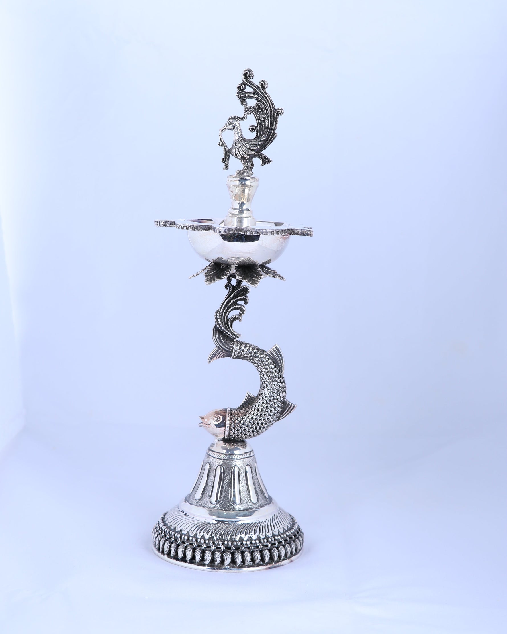 Silver-tone standing samai holder with bird crest flame dish and curled serpent figure