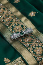 Sterling silver brooch with green center and crystal detail